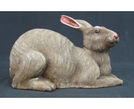 ORIENTAL CERAMIC STUDY OF A RECUMBENT HARE, with three individual impressed seal marks to base, 27cm long and 16cm high appro