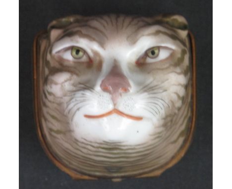 19TH CENTURY PORCELAIN SNUFF BOX in the form of a cat's head, with yellow metal mounted, hinged cover decorated with a spray 