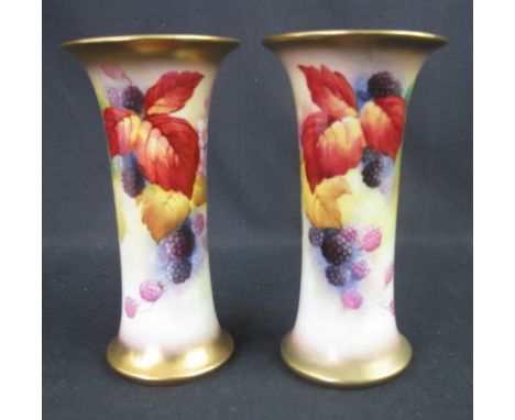 PAIR OF ROYAL WORCESTER PORCELAIN VASES of cylindrical form with flared necks, painted and signed by Kitty Blake, with flower