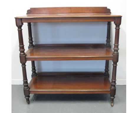 VICTORIAN MAHOGANY THREE TIER DUMB WAITER, having carved gallery top above turned, fluted and beaded supports, standing on ba