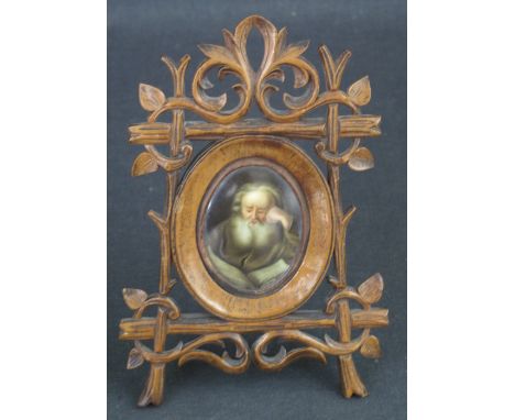 19TH CENTURY PORTRAIT MINIATURE. 'The Scholar', initialed 'E' verso, ivory, 5.4cm approx. Within miniature pierced wooden eas