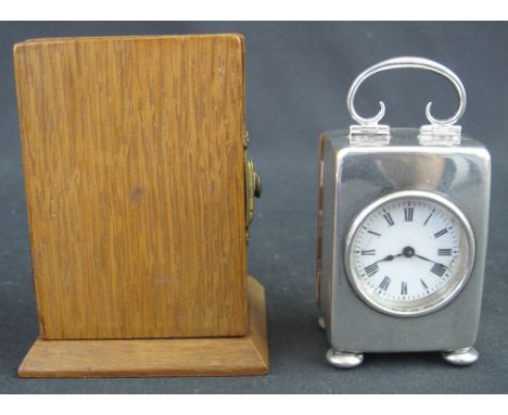 FRENCH SILVER CASED MINIATURE CARRIAGE CLOCK, having circular enamel Roman face, the plain case with scrolled folding loop ha