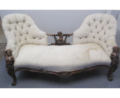 VICTORIAN WALNUT DOUBLE ENDED CONVERSATION BUTTON BACK SOFA, having well carved term figures on either end, with cherub and b