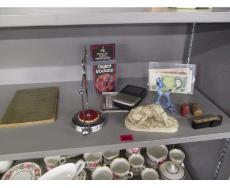A 1937 commemorative gong, mixed items to include a composition dog, vintage Casio television, Dice, a £5 note, a £1 note and