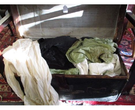A leather trunk containing vintage textiles and fabrics