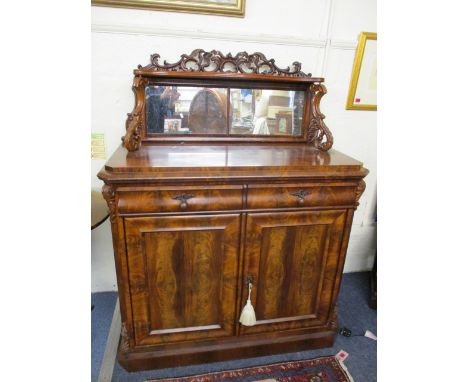 A 19th century European mahogany chiffoniere, carved and pierced crest rail over an extended mirror back, with single shelf s