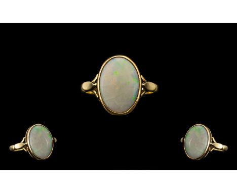 Ladies Attractive 9ct Gold Single Stone Opal Set Ring.  Full hallmark for Birmingham 1966.  Pale opal of oval shape, with ora