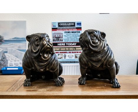 A Pair of Reproduction Bronze Figures of Standing Bull Dogs with expressive faces. Measuring 21 inches high.