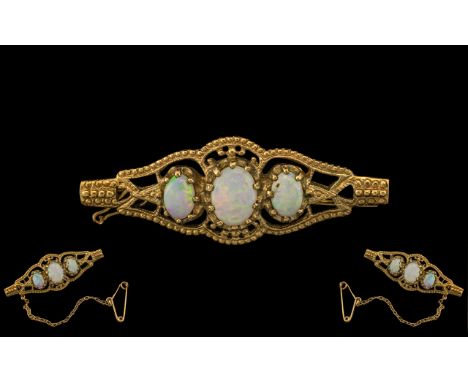 Ladies 9ct Gold 3 Stone Opal Set Ornate Brooch, with attached safety chain, with full hallmark for 9 ct -375.  The three oval