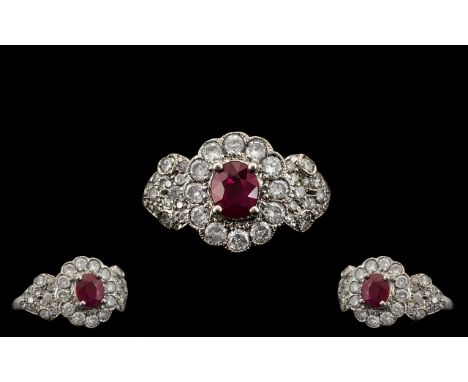 Ladies Attractive 18ct White Gold Ruby and Diamond Set Stylish Cluster Ring, the central ruby surrounded by twelve pave set d