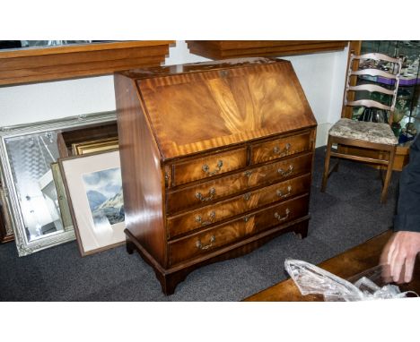 A Georgian Style Mahogany Bureau the fall front with green tooled leather top, fitted interior with pigeon holes and drawers 