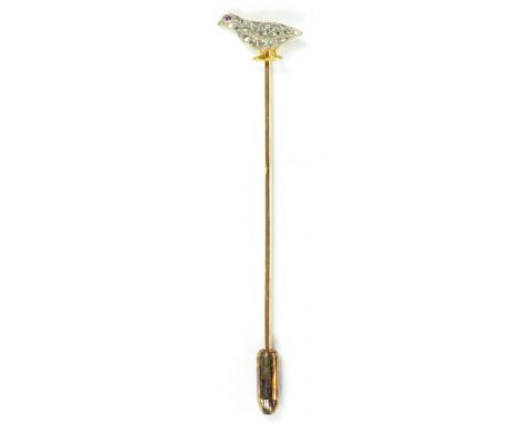 A GOLD STICK PIN, THE DIAMOND PAVÉ SET TERMINAL IN THE FORM OF A GROUSE WITH RUBY EYE, CIRCA 1930