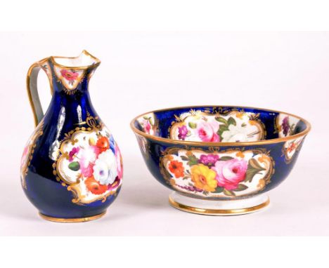 A COALPORT MINIATURE COBALT GROUND JUG AND BASIN, PAINTED IN WORCESTER STYLE WITH FLOWERS IN GILT SCROLLING RESERVES, JUG 9.5