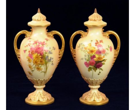 A PAIR OF ROYAL WORCESTER TWO HANDLED OVIFORM VASES AND COVERS,  DECORATED WITH WILD FLOWERS ON A SHADED APRICOT GROUND, 22CM