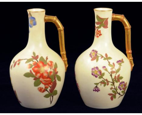 A PAIR OF ROYAL WORCESTER BAMBOO HANDLED EWERS, DECORATED WITH WILD FLOWERS ON AN OLD IVORY GROUND, 20CM H, PRINTED MARK, CIR