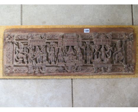 An Eastern hardwood carved panel, 29cm x 79cm, on later backing - for condition please see images 