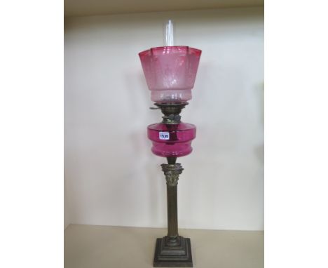 An oil lamp with cranberry font and cranberry etched shade, 82cm tall, good condition 
