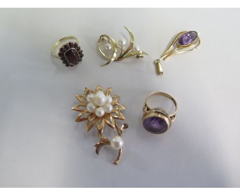 A small collection of gold jewellery, a 14ct gold floral style brooch with pearls, a 14 carat gold band ring with amethyst st