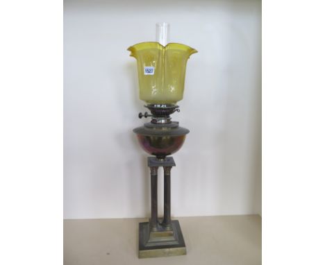 A four pillar brass oil lamp with yellow glass etched shade, 73cm tall, minor chips to shade base, otherwise good 