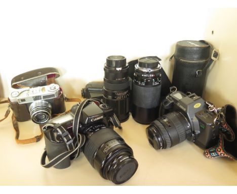 two Canon 35mm cameras EOS600 and EOS10 with 4 lenses and a Samoca camera and flash 