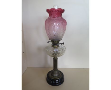 An oil lamp with an etched cranberry shade and clear glass font, 66cm tall, overall good condition 