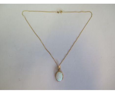 a hallmarked 9ct yellow gold opal pendant on a 40cm chain, approx 4.2 grams, new condition, ex jewellers stock 