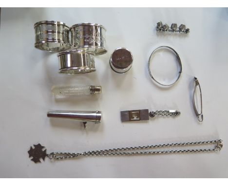 A selection of assorted silver to include three serviette rings, a pendant, pendant and chain, bangle, brooch, pot, cheroot h