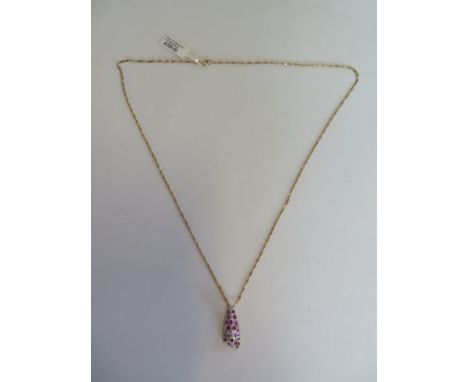 A 9ct yellow gold ruby and diamond leo pendant necklace chain, 44cm long - pendant 2cm long - approx 2.9 grams, new condition