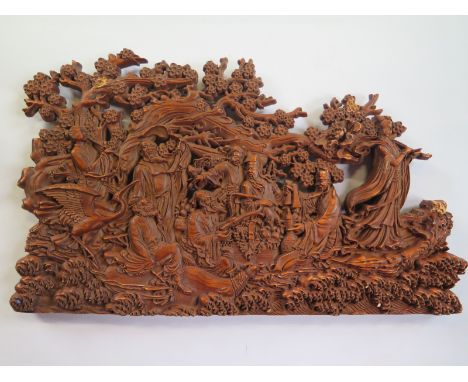 A carved wooden oriental panel 28 x 17cm, overall good, some minor chips 
