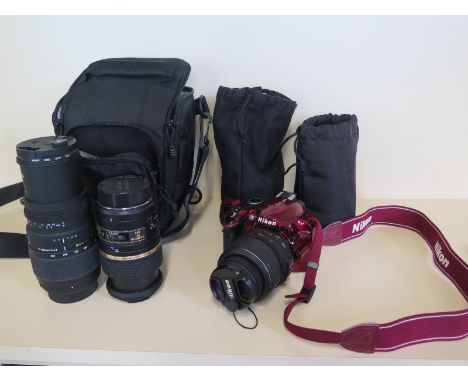 A Nikon D3200 digital camera with an extra Tamson SPDi lense and a Sigma DG lense, two batteries and charger, in clean workin