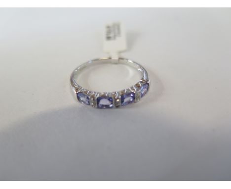 A hallmarked 9ct white gold tanzanite diamond ring, size P, approx 1.9 grams, new condition, ex jewellers stock 