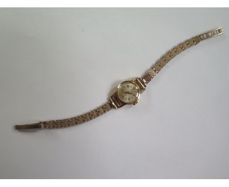 An 18ct yellow gold ladies manual wind MuDu wristwatch on a 9ct yellow gold strap, back has minor dents, running in saleroom,