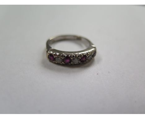 An 18ct white gold hallmarked diamond and ruby seven stone ring, size P, approx 6 grams, valued in 1987 for insurance for £50