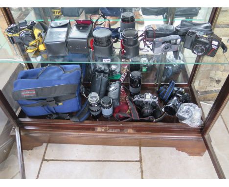 A collection of cameras and equipment to include a Nikon F3 SLR camera, Nikon FA, Minolta AF 9000, assorted lenses and other 