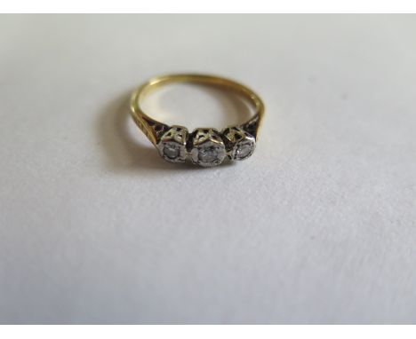 An 18ct and platinum three stone diamond ring, size L - approx 2.54 grams, some usage but generally good, marked 18ct 