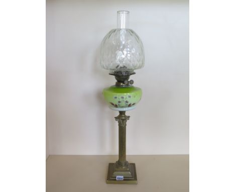 An oil lamp with enamel glass font and clear glass bell shaped shade, 73cm tall, slight wear to enamel, otherwise good 