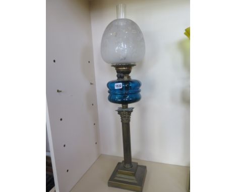 An oil lamp with blue glass font and etched shade, 79cm tall, minor chips to shade base, otherwise generally good 