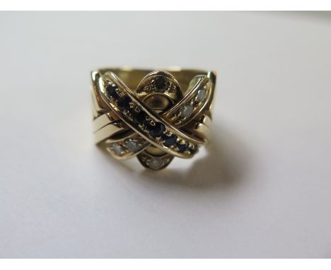 A diamond and Sapphire crossover ring possibly American ,tests to approximately 14 carat, ring size T, no hallmarks , approx 