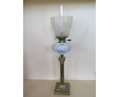 An oil lamp with an etched shade and moulded glass font, 80cm tall 