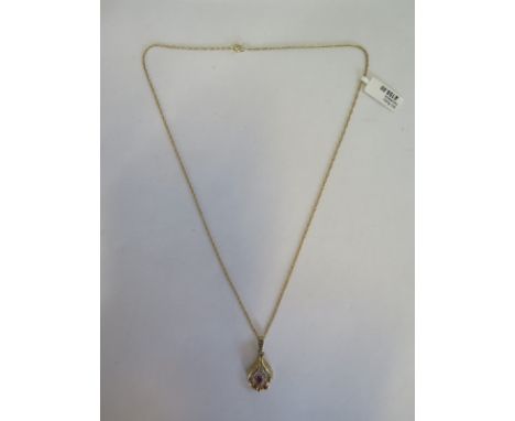 A 9ct yellow gold ruby pendant necklace on a 40cm chain pendant, pendant 2cm long, marked 375 pre-owned, approx 1.7 grams - g