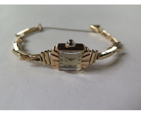 A 9ct gold ladies Avia manual wind wrist watch with sprung 9ct strap, replacement winder, running in saleroom, approx 14 gram
