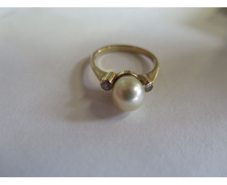 A hallmarked 9ct yellow gold pearl and diamond ring - size P, approx 3.5 grams - pearl 7x8mm approx - minor scratches to pear