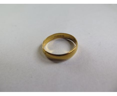 A 22ct gold hallmarked band ring, size R, approx 3.5 grams - some usage marks but generally good 