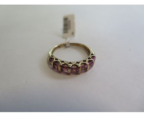 A hallmarked 9ct yellow gold pink topaz half eternity ring - size O - approx 2.7 grams - new condition, ex jewellers stock 