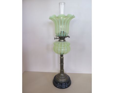 An oil lamp with stripped vaseline glass shade and font - 72cm tall, minor chips to base of shade, otherwise good 