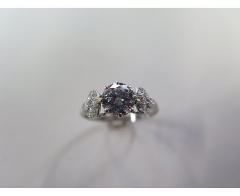 A platinum solitaire dress ring incorporating one round transitional brilliant cut diamond, secured in a claw collet setting 