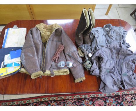 A 1942 ministry leather flying jacket size 6 with two  flying suits one size 5, a pair of flying goggles, a leather flying he
