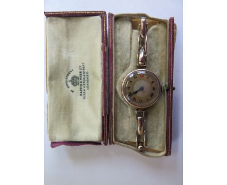 A 9ct yellow gold 15 jewel ladies wristwatch on a 9ct sprung strap, 28mm wide including button, manual wind, running in saler