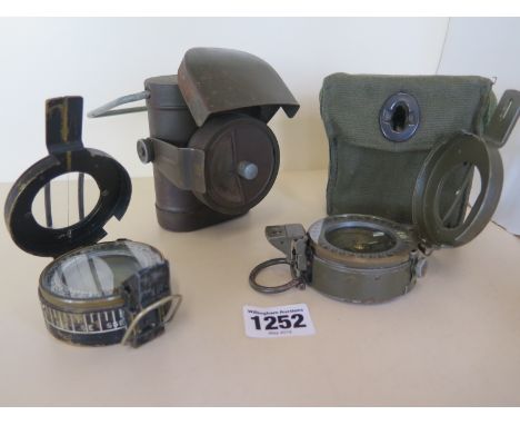 A Military Stanley of London compass 10841 and a MKIII 1940 T G Co Ltd compass No B30230 and a military torch 
