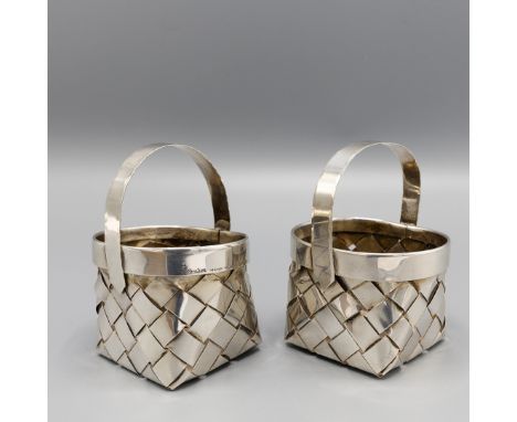 A PAIR OF SILVER MINIATURE CONDITMENT HOLDERS. one stamped Cartier, woven silver bodies, 104 grams, 9cm H.